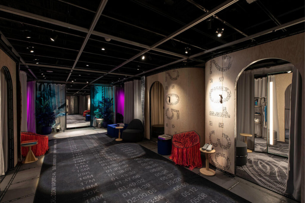Immersive fitting room corridor at Nike House of Innovation with moody lighting, digital textures, and experiential design elements blending technology and retail.