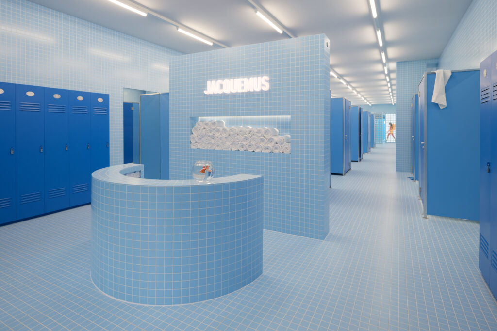 Interior view of Jacquemus Le Bleu at Selfridges, featuring a tiled blue locker-room design with minimalist, monochrome detailing.