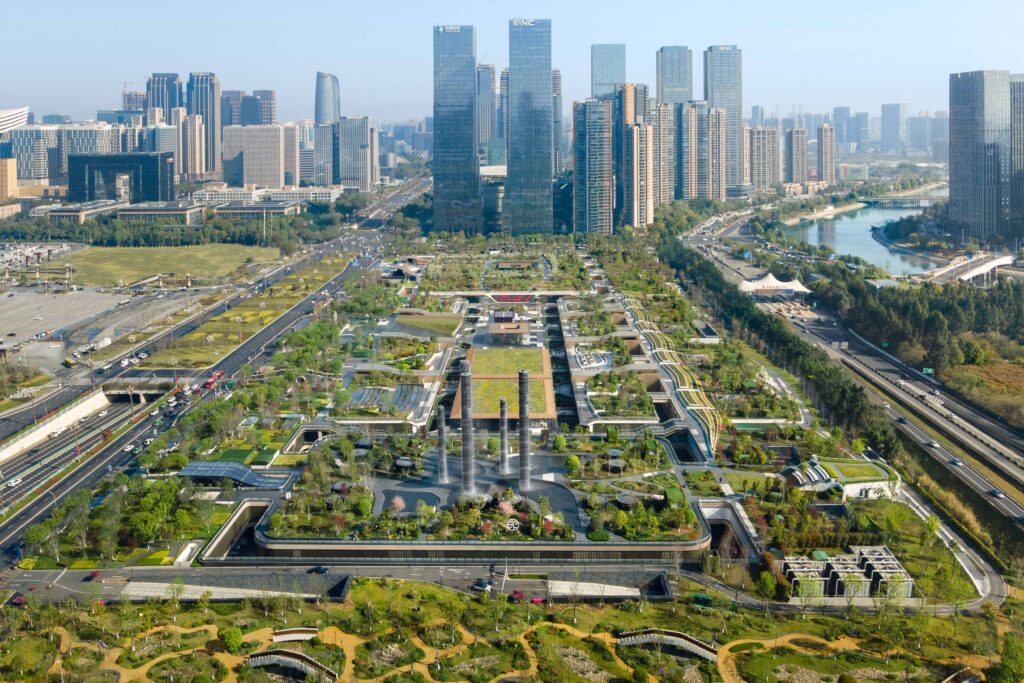 Aerial view of SKP Chengdu, featuring the expansive green rooftop park integrated with the cityscape, blending urban density with landscaped terraces and sustainable architecture.
